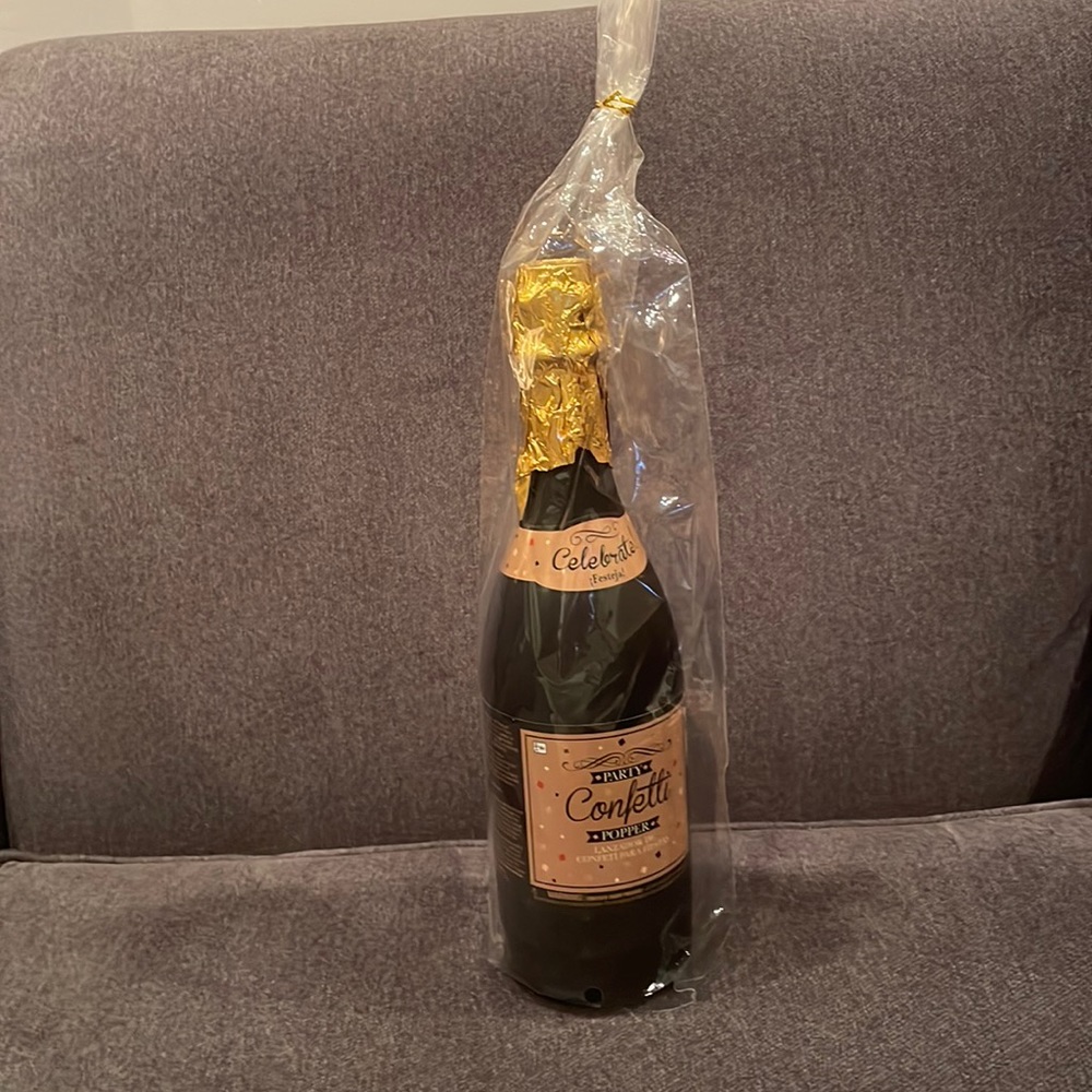 Party confetti popper champagne bottle shaped.